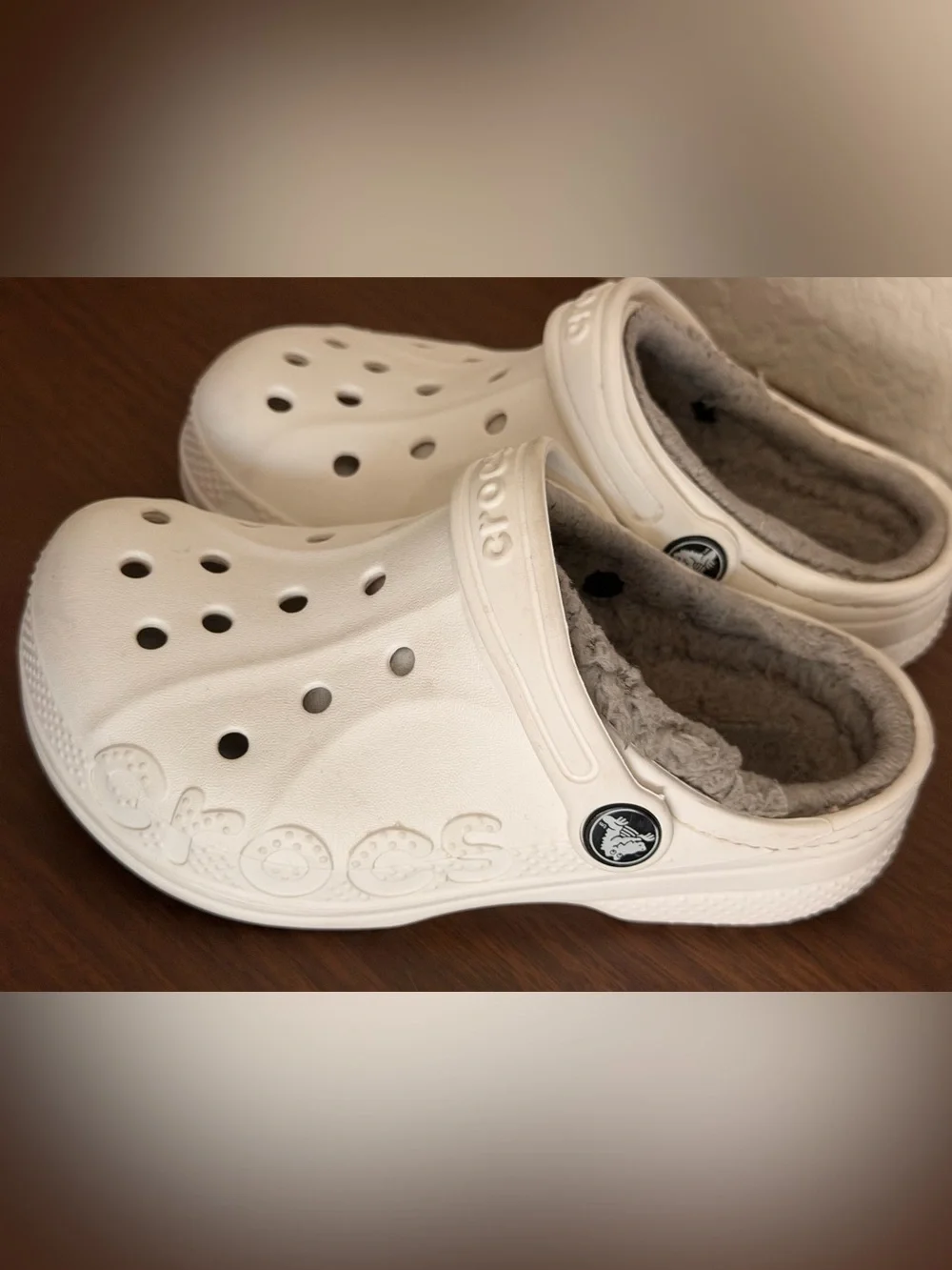 white Crocs Baya Lined Clogs featuring a cozy grey faux-fur lining. C-12